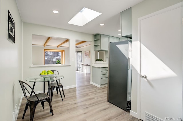 kitchen featuring recessed lighting, baseboards, freestanding refrigerator, open shelves, and light wood finished floors