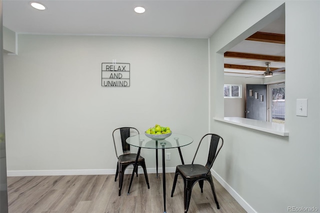 dining space featuring beamed ceiling, recessed lighting, wood finished floors, and baseboards