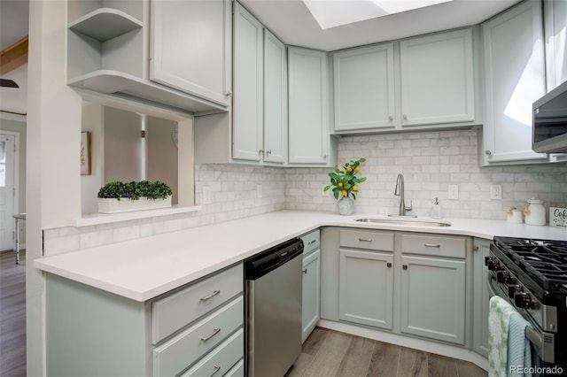 kitchen with stainless steel appliances, light countertops, and a sink