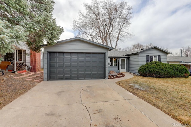 single story home featuring a garage, concrete driveway, and a front lawn