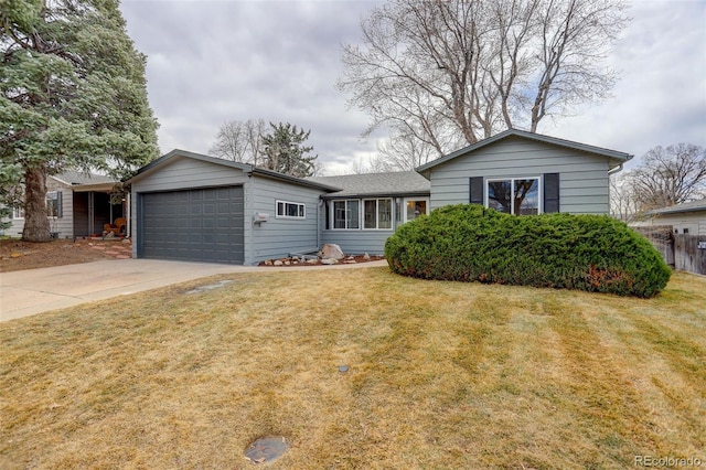 single story home featuring a garage, driveway, and a front lawn