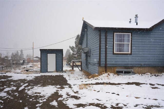 711 Clark St, Fairplay, CO 80440 - view of snowy exterior with an outdoor structure and a storage unit
