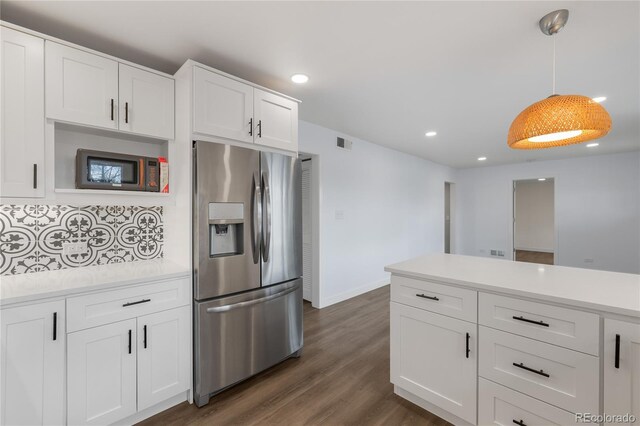 kitchen featuring stainless steel fridge with ice dispenser, light countertops, white cabinets, dark wood-style flooring, and visible vents