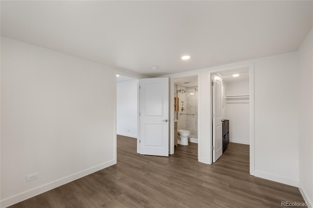 unfurnished bedroom featuring wood finished floors and baseboards