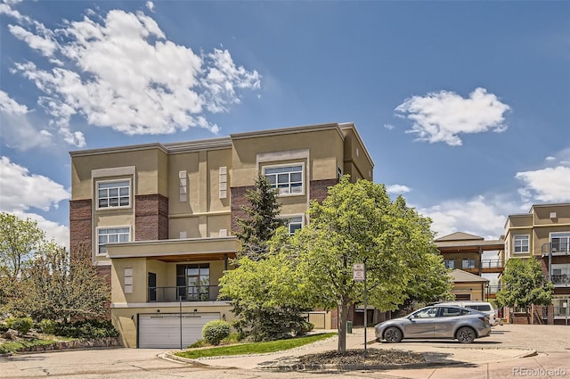 5401 S Park Terrace Ave Unit 109A, Greenwood Village, CO 80111 - view of front of home featuring stucco siding, a garage, and driveway