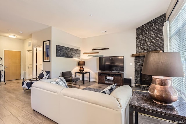 5401 S Park Terrace Ave Unit 109A, Greenwood Village, CO 80111 - living room featuring light wood finished floors and a stone fireplace