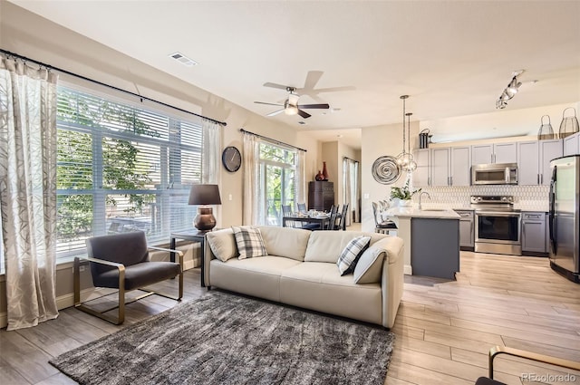 5401 S Park Terrace Ave Unit 109A, Greenwood Village, CO 80111 - living area featuring light wood-style flooring and a ceiling fan