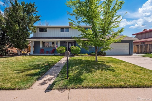 traditional-style home featuring fence, a front yard, an attached garage, driveway, and a porch