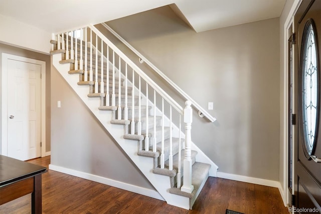stairs with baseboards and wood finished floors