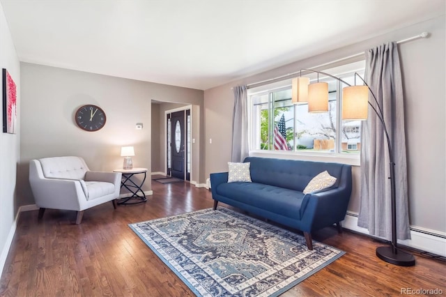 living area featuring baseboards and wood finished floors