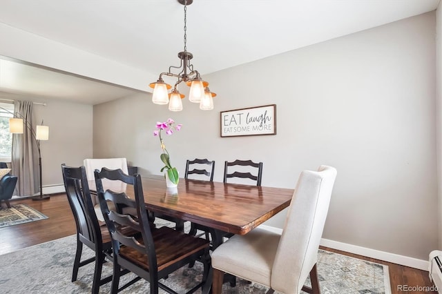 dining space featuring baseboard heating, baseboards, a baseboard radiator, dark wood-style floors, and a notable chandelier