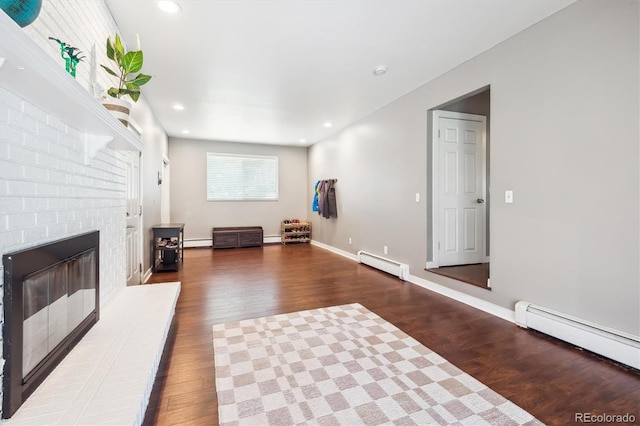 interior space with a baseboard radiator, wood finished floors, and baseboard heating