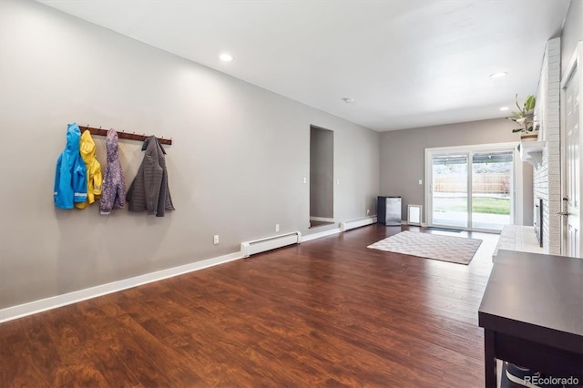 unfurnished living room featuring baseboards, a baseboard radiator, wood finished floors, and recessed lighting