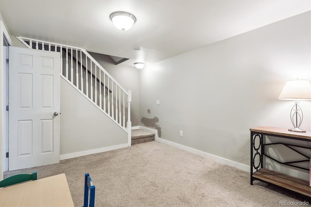 interior space featuring baseboards, carpet flooring, and stairs