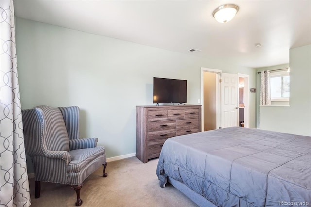 carpeted bedroom featuring baseboards and visible vents