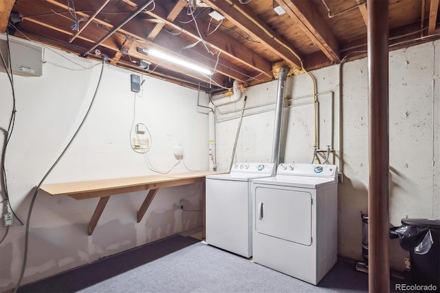 clothes washing area with laundry area, carpet flooring, and washing machine and dryer