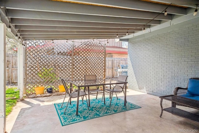 view of patio featuring fence and outdoor dining space