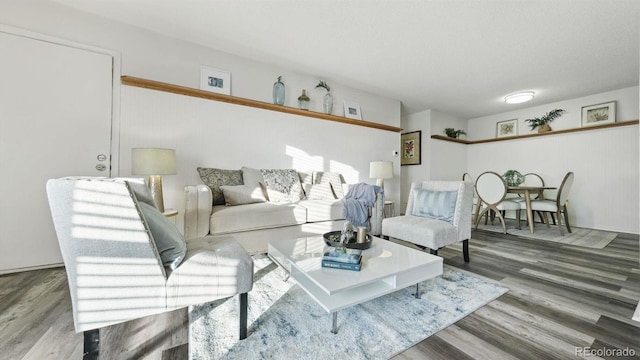 living room with wood-type flooring and a textured ceiling