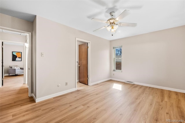 unfurnished bedroom featuring light wood-style floors, visible vents, and baseboards