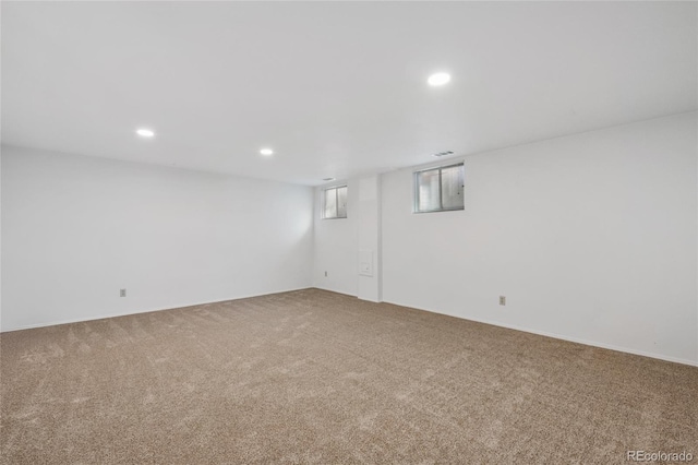 carpeted spare room featuring visible vents and recessed lighting