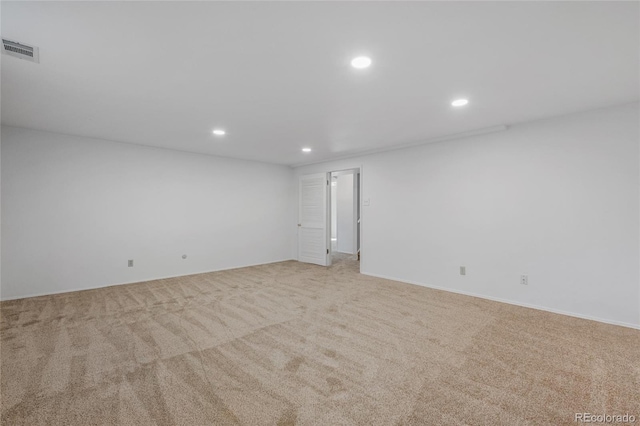 unfurnished room with visible vents, light colored carpet, and recessed lighting