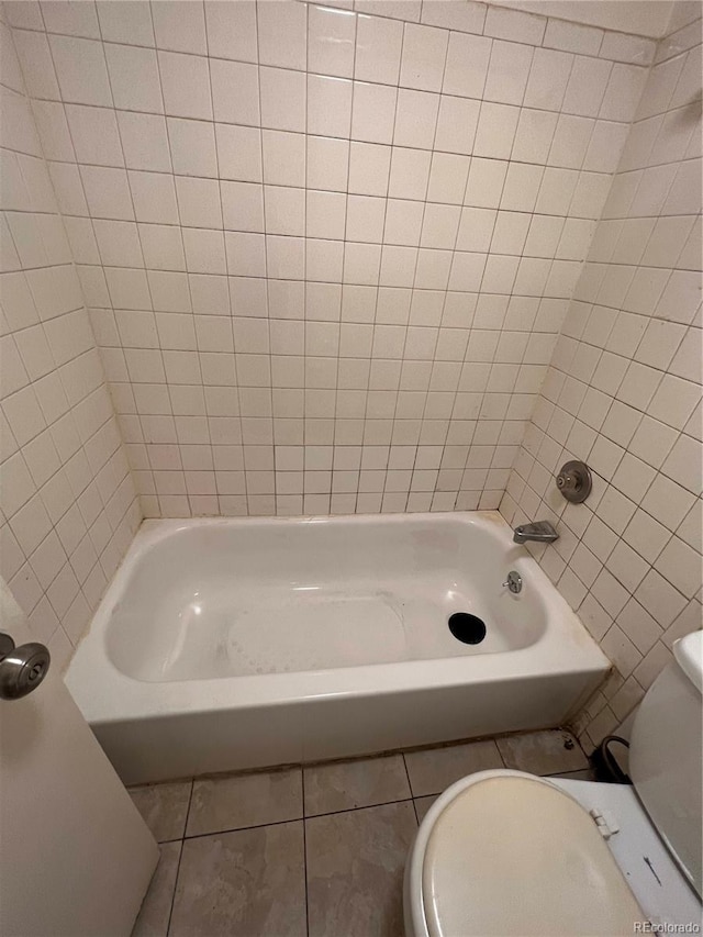 bathroom with toilet and tile patterned floors