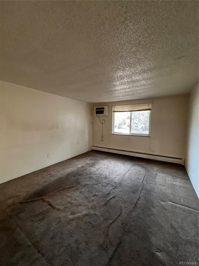 carpeted empty room featuring a textured ceiling, a baseboard heating unit, and a wall mounted air conditioner