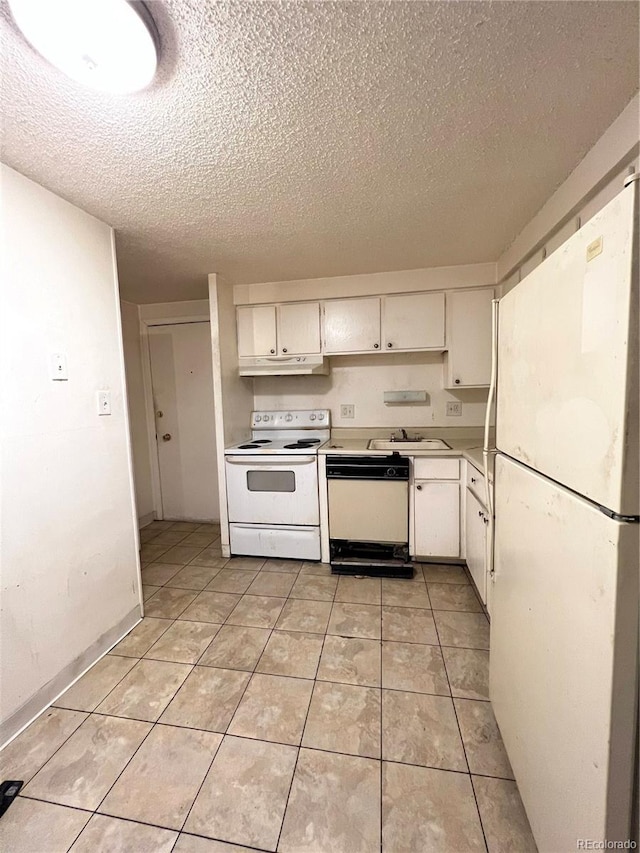 kitchen featuring white appliances, a textured ceiling, light tile patterned flooring, sink, and white cabinetry