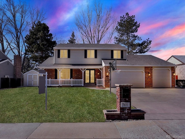7631 Oak St, Arvada, CO 80005 - traditional home featuring a garage, brick siding, covered porch, a storage shed, and driveway
