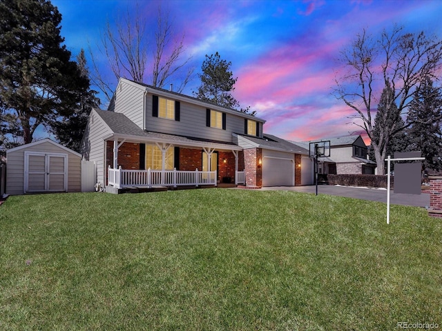 7631 Oak St, Arvada, CO 80005 - traditional-style house with a porch, brick siding, concrete driveway, a garage, and a storage shed