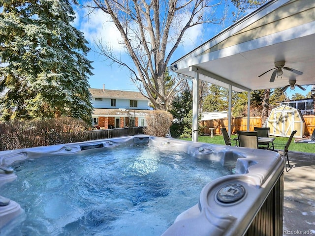 7631 Oak St, Arvada, CO 80005 - view of pool with a storage shed, a ceiling fan, a fenced backyard, and a hot tub