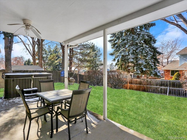 7631 Oak St, Arvada, CO 80005 - fenced backyard featuring a hot tub, ceiling fan, a patio area, and outdoor dining space