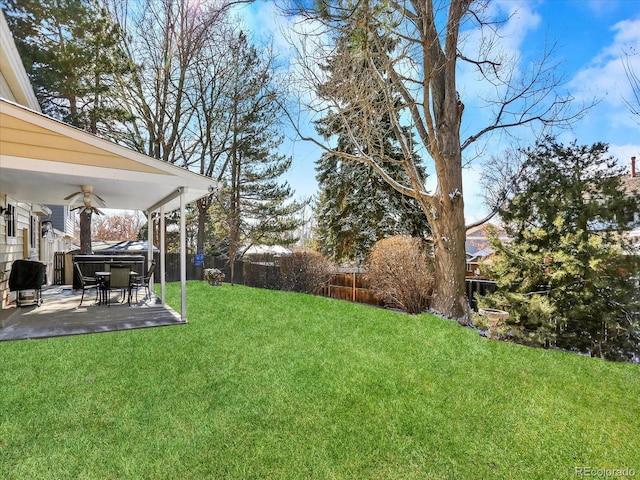7631 Oak St, Arvada, CO 80005 - fenced backyard featuring a patio area and ceiling fan