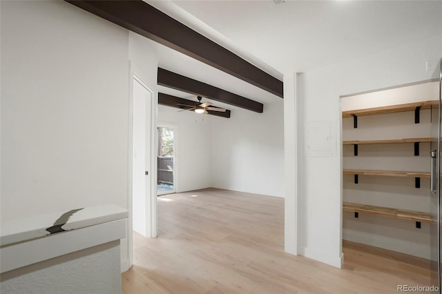 hallway featuring beamed ceiling and light hardwood / wood-style flooring