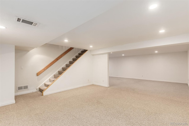 finished below grade area with stairway, visible vents, carpet flooring, and recessed lighting