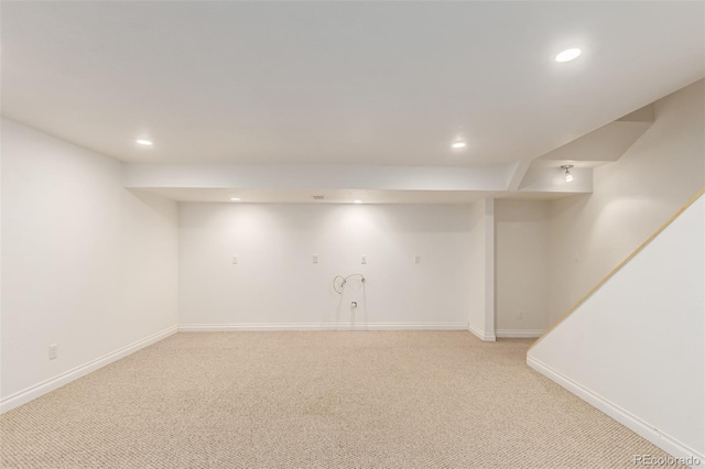 finished basement featuring baseboards, recessed lighting, and light colored carpet