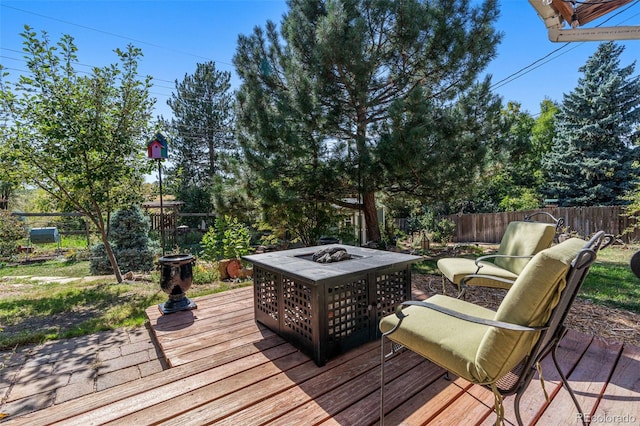 wooden terrace featuring a fire pit