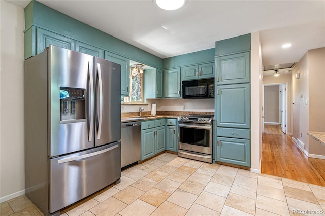 kitchen with sink, stainless steel appliances, and light tile patterned flooring