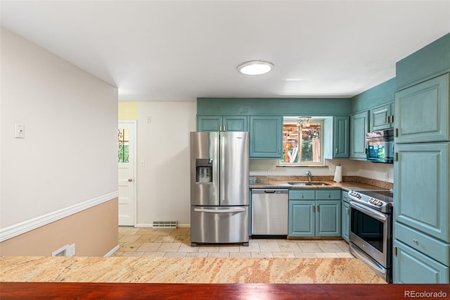 kitchen featuring sink, stainless steel appliances, and light tile patterned flooring