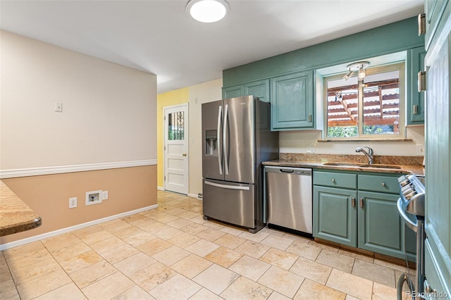 kitchen featuring green cabinetry, stainless steel appliances, and sink