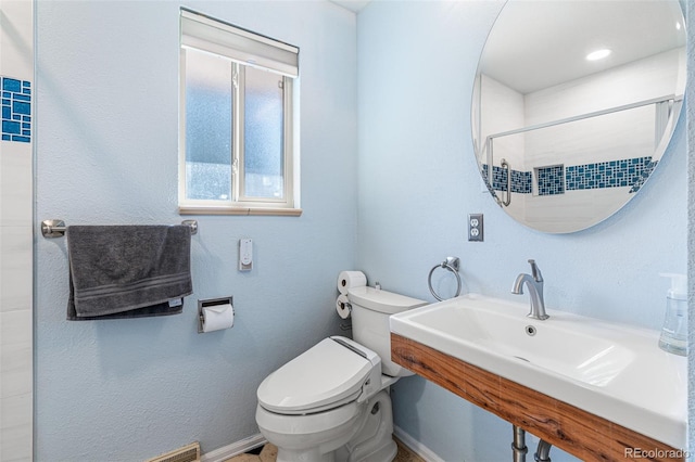 bathroom featuring sink and toilet