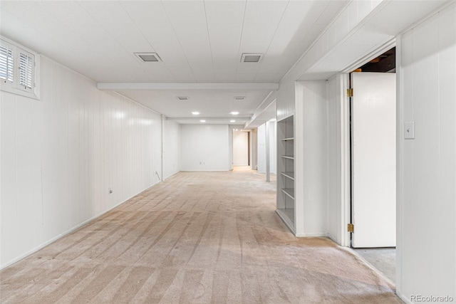 hallway with light colored carpet and built in features