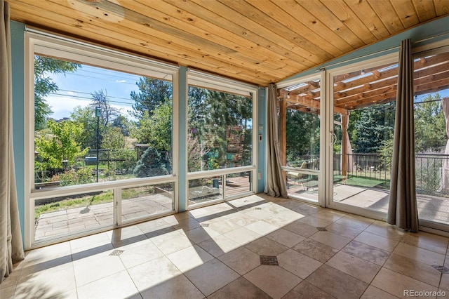 unfurnished sunroom featuring vaulted ceiling and wooden ceiling