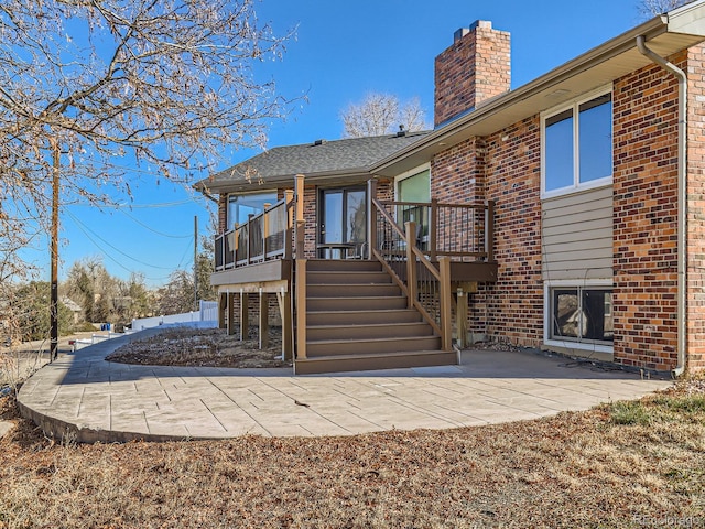 rear view of house with a patio area and a sunroom