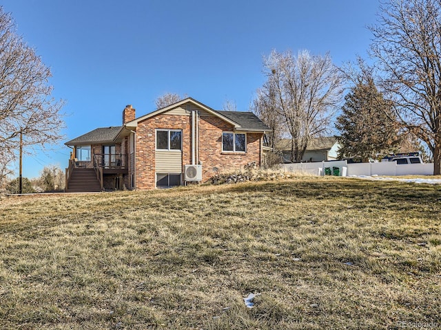 exterior space featuring a yard and ac unit