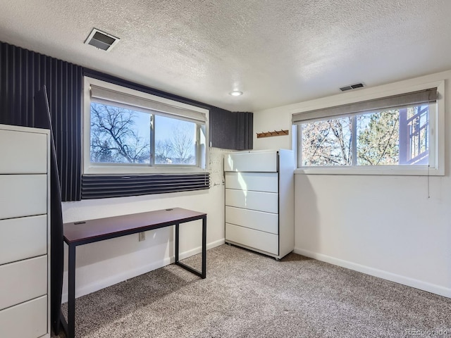 interior space with fridge, a textured ceiling, and carpet flooring