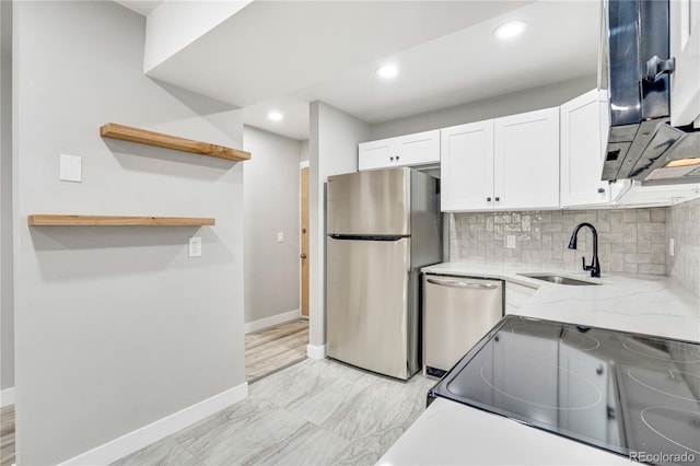 kitchen featuring sink, stainless steel appliances, white cabinets, and light stone counters