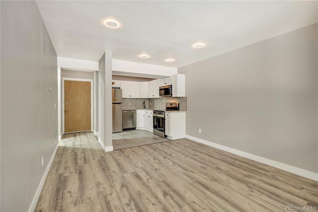 unfurnished living room with light hardwood / wood-style flooring