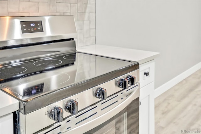 details with white cabinetry and stainless steel stove