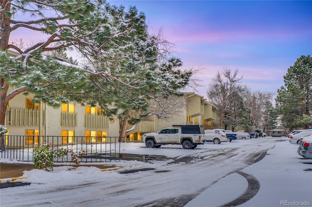 view of snow covered parking area